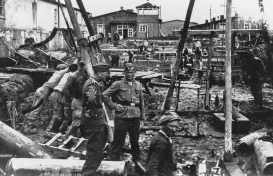 SS men supervise laborers at construction work. Neuengamme concentration camp